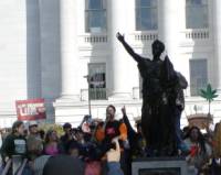 Rocker T sings as marchers converge on the State Street steps at the Capitol.